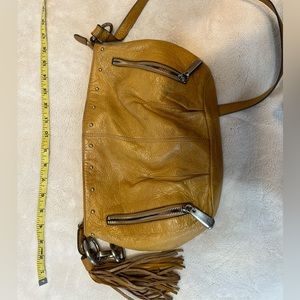 Mustard B Makowsky leather bag with silver hardware.